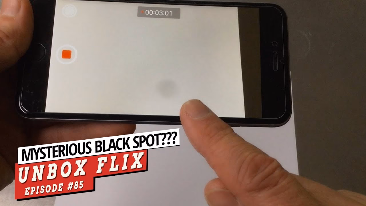 What causes a black spot on my iPhone camera?